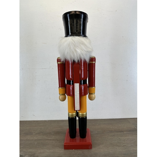 524 - A wooden hand-painted floor standing soldier nutcracker - approx. 59cm high