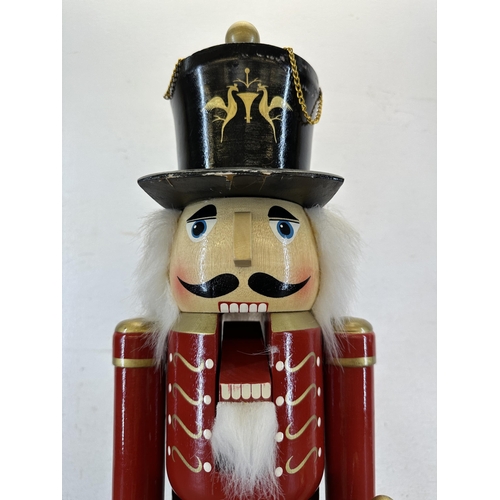 524 - A wooden hand-painted floor standing soldier nutcracker - approx. 59cm high