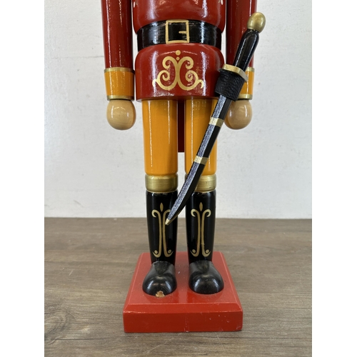 524 - A wooden hand-painted floor standing soldier nutcracker - approx. 59cm high