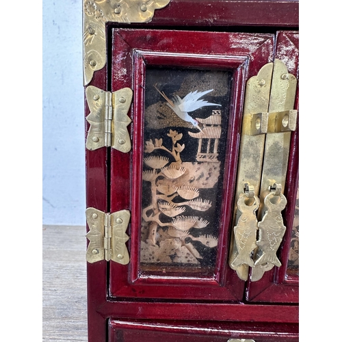 527 - A mid 20th century Chinese hardwood and brass miniature jewellery cabinet with cork diorama panelled... 