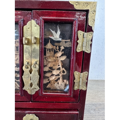 527 - A mid 20th century Chinese hardwood and brass miniature jewellery cabinet with cork diorama panelled... 