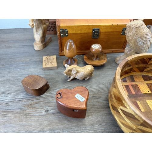 543 - A collection of treenware to include carved fruit, shoe last, carved owl figurine, rectangular stora... 