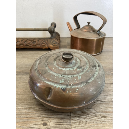 426 - A collection of 19th century and later metalware to include copper kettle, cast iron and brass fire ... 