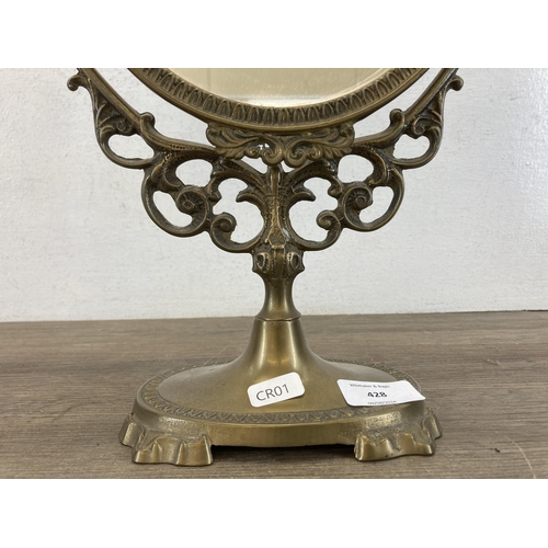 428 - A Rococo style brass bathroom mirror - approx. 49cm high