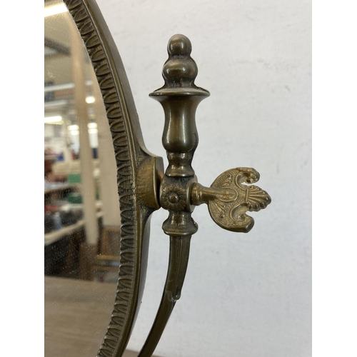 428 - A Rococo style brass bathroom mirror - approx. 49cm high