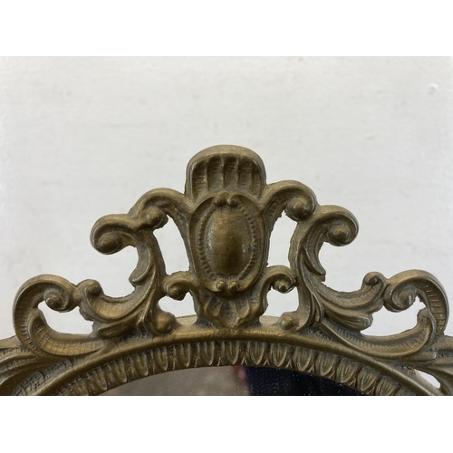 428 - A Rococo style brass bathroom mirror - approx. 49cm high