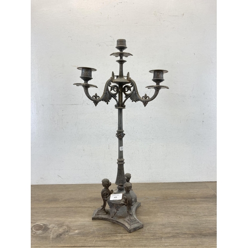 429 - A 19th century cast metal four branch candelabra - approx. 56cm high