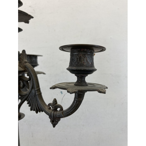 429 - A 19th century cast metal four branch candelabra - approx. 56cm high