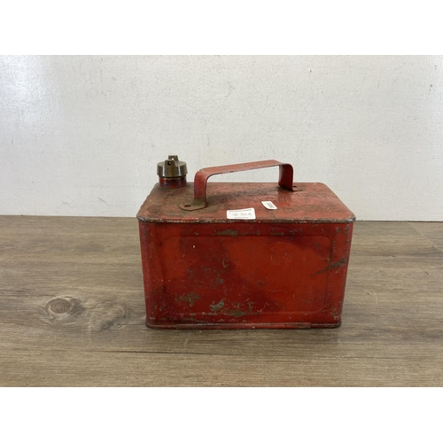 430A - A mid 20th century red metal petrol can with brass top