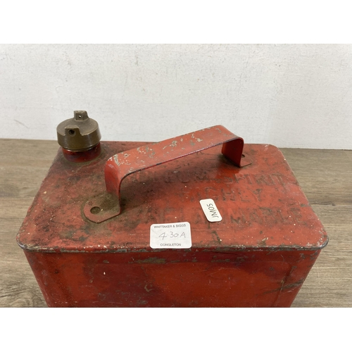 430A - A mid 20th century red metal petrol can with brass top