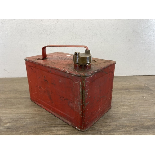 430A - A mid 20th century red metal petrol can with brass top