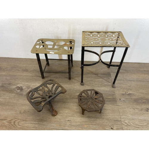 431 - Four 19th century brass and cast metal trivet stands - largest approx. 29cm high