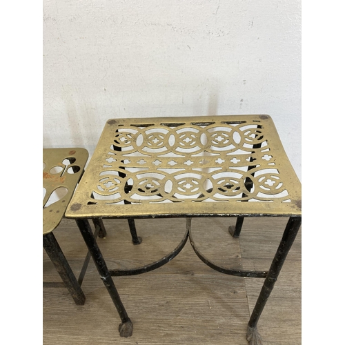 431 - Four 19th century brass and cast metal trivet stands - largest approx. 29cm high