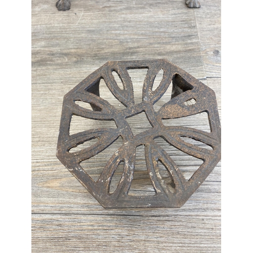 431 - Four 19th century brass and cast metal trivet stands - largest approx. 29cm high