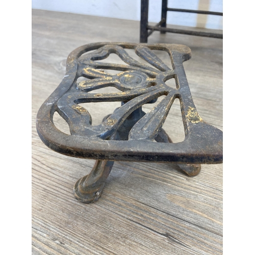 431 - Four 19th century brass and cast metal trivet stands - largest approx. 29cm high