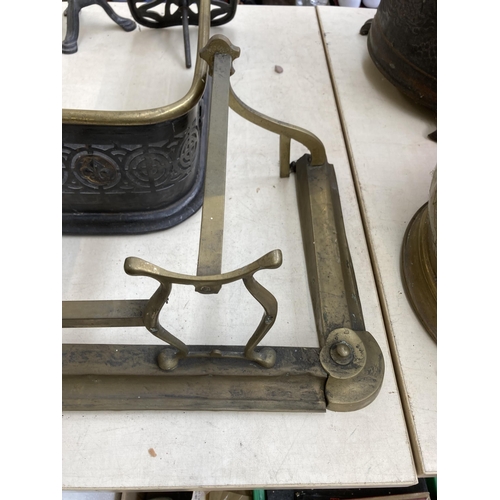 433 - A collection of 19th century and later metalware to include two brass and cast metal fire fenders, 1... 