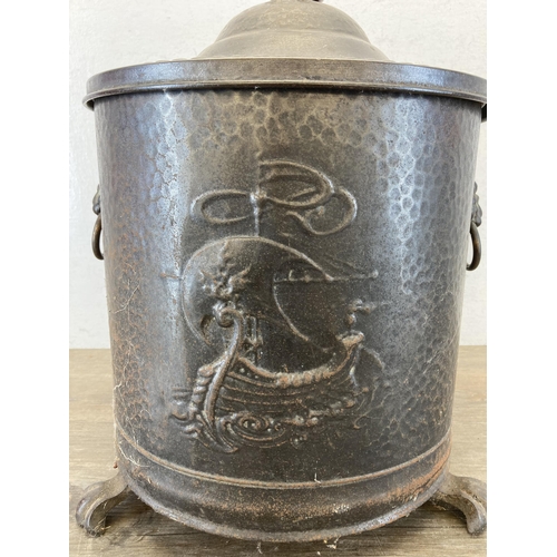 434 - A vintage cast metal coal bucket with lion head handles, lion paw feet and brass spherical top - app... 