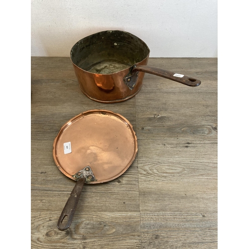 447 - Two 19th century copper and cast metal lidded saucepans