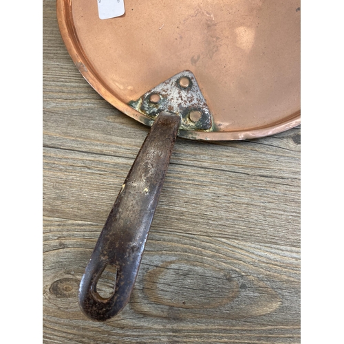 447 - Two 19th century copper and cast metal lidded saucepans