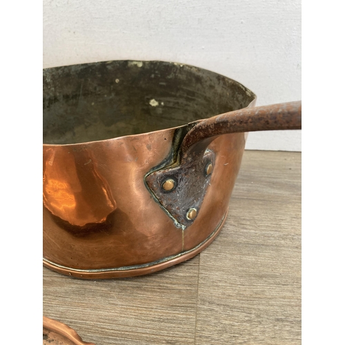 447 - Two 19th century copper and cast metal lidded saucepans