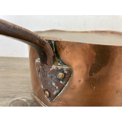 447 - Two 19th century copper and cast metal lidded saucepans