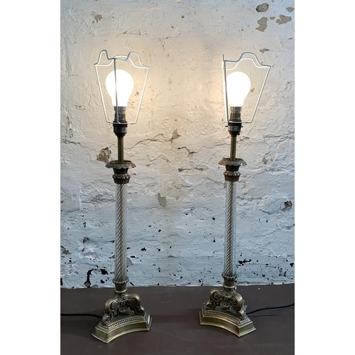 22 - A pair of 19th century style gilt metal table lamps on tripod supports - approx. 52cm high