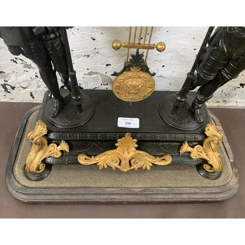 236 - A French Japy Freres gilded spelter figural two train clock with glass dome, pendulum and key on ebo... 