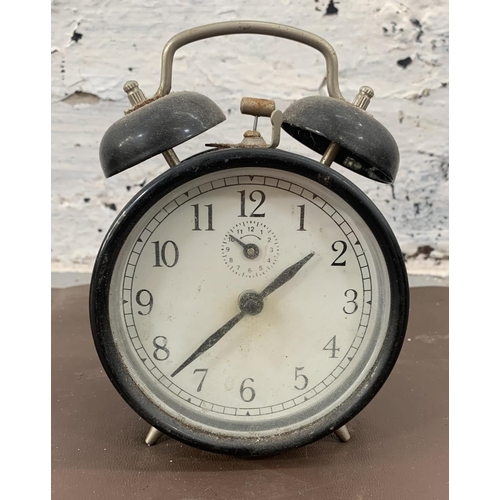 245 - Three various clocks, two Smiths oak cased mantel and one black metal alarm