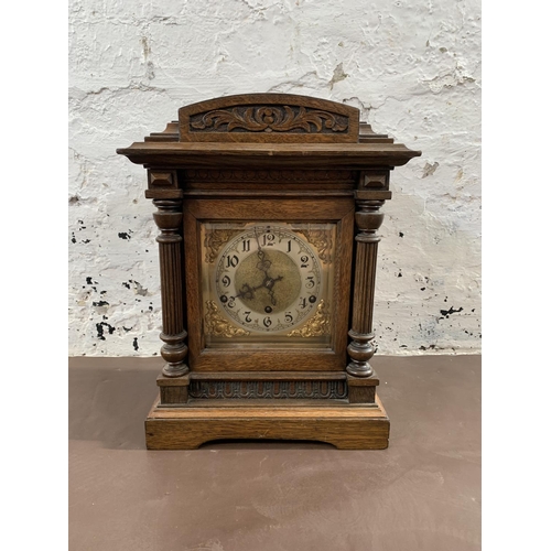 46 - An early 20th century German Kienzle carved oak cased chiming mantel clock with pendulum and key - a... 