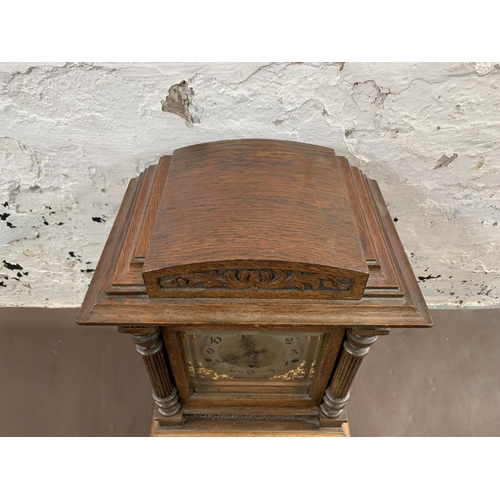 46 - An early 20th century German Kienzle carved oak cased chiming mantel clock with pendulum and key - a... 