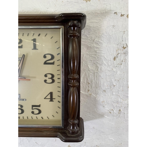 54 - A mid 20th century Cartex plastic cased quartz wall clock - approx. 33cm high x 38cm wide