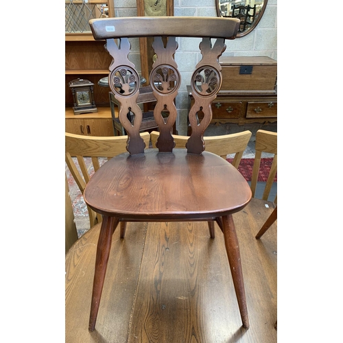 61 - A mid 20th century Ercol Old Colonial No. 377 elm and beech circular drop leaf dining table and four... 