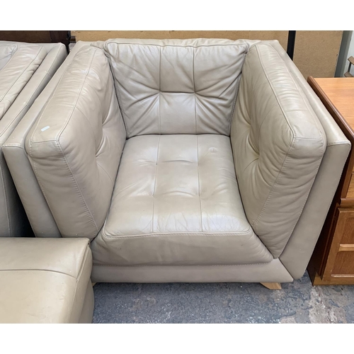 66 - A modern beige leather three piece lounge suite comprising two seater sofa, armchair and footstool