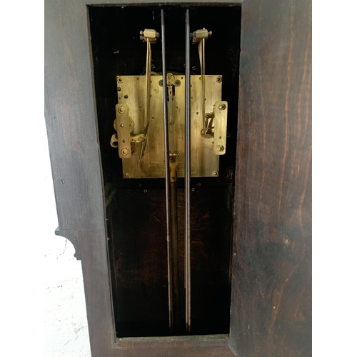 94 - An Art Deco Enfield Clock Co. London Ltd oak cased chiming granddaughter clock with two keys and pen... 