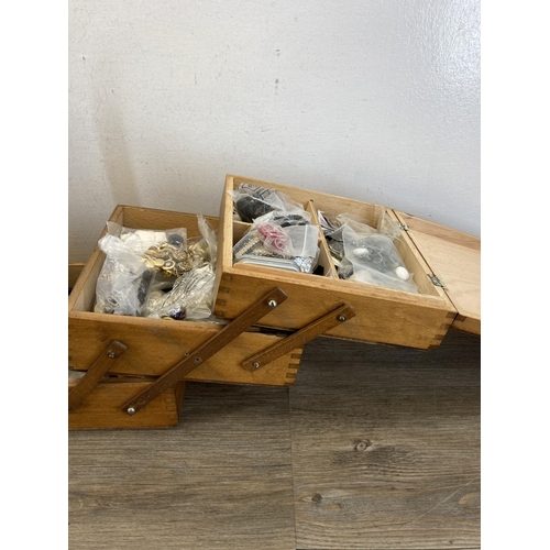 516A - A mid 20th century oak and beech cantilever sewing box containing various sewing accessories to incl... 