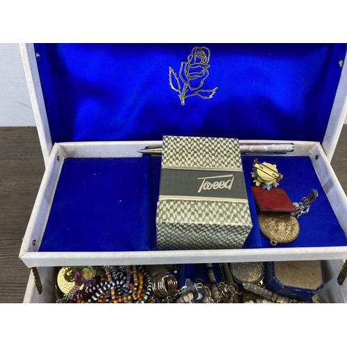 477 - A white two tier jewellery box containing a collection of costume jewellery to include natural pearl... 