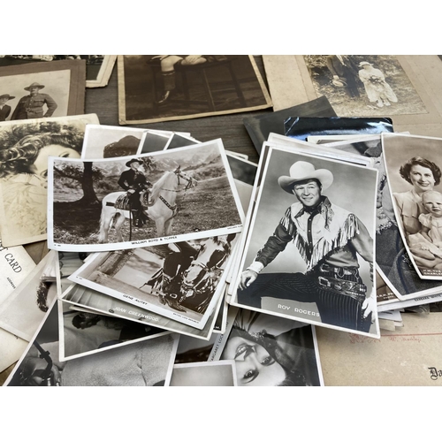 498 - A collection of antique and later black and white photographs and postcards