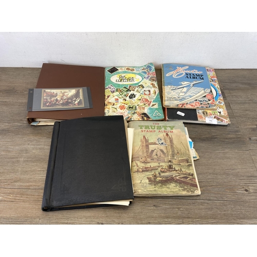 502 - Five stamp albums containing a collection of worldwide stamps