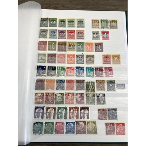 504 - Five stamp albums containing a collection of worldwide stamps