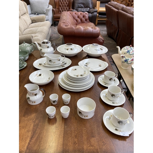 394 - A collection of Royal Doulton Westwood dinnerware to include three cups and saucers, two tureens, co... 