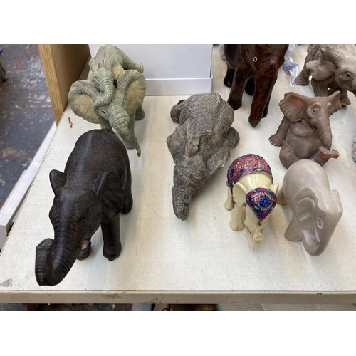 417 - A collection of elephant figurines, paperweights and decorative items to include boxed Objets D'Art ... 