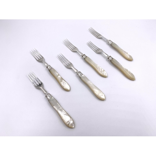 2129 - Six antique hallmarked London silver and mother of pearl dessert forks, three William Hutton & Sons ... 