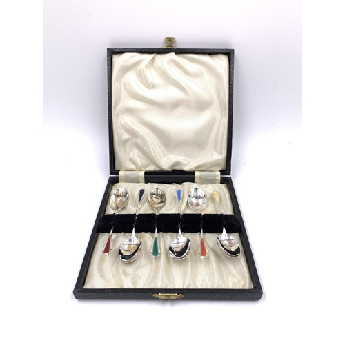 2144 - A cased set of six Elizabeth II James Fenton & Co hallmarked Birmingham silver and enamel coffee spo... 