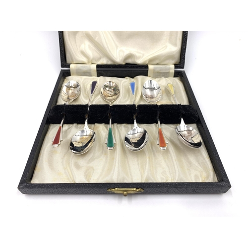 2144 - A cased set of six Elizabeth II James Fenton & Co hallmarked Birmingham silver and enamel coffee spo... 