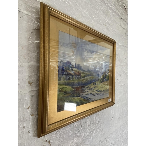 314 - A 20th century gilt framed watercolour of a landscape scene signed lower left - approx. 50cm high x ... 