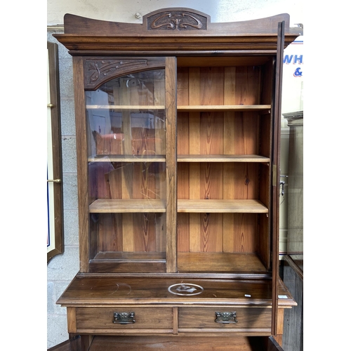 1 - An Art Nouveau carved walnut bookcase - approx. 222cm high x 106cm wide x 48cm deep