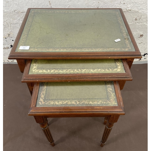 111 - A mahogany and green leather nest of tables - approx. 52cm high x 53cm wide x 39cm deep