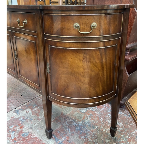 112 - A Bevan Funnell Reprodux mahogany demi lune sideboard on tapering supports - approx. 87cm high x 137... 