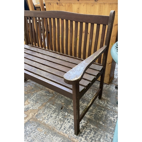 125 - A teak two seater garden bench - approx. 86cm high x 123cm wide x 57cm deep