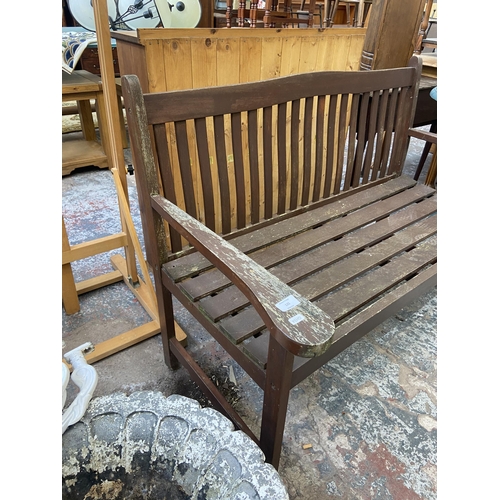 125 - A teak two seater garden bench - approx. 86cm high x 123cm wide x 57cm deep